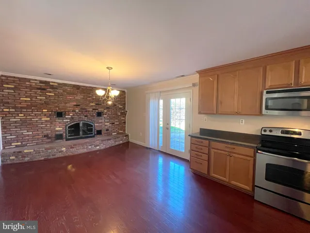 a view of a kitchen with a sink and a stove top oven
