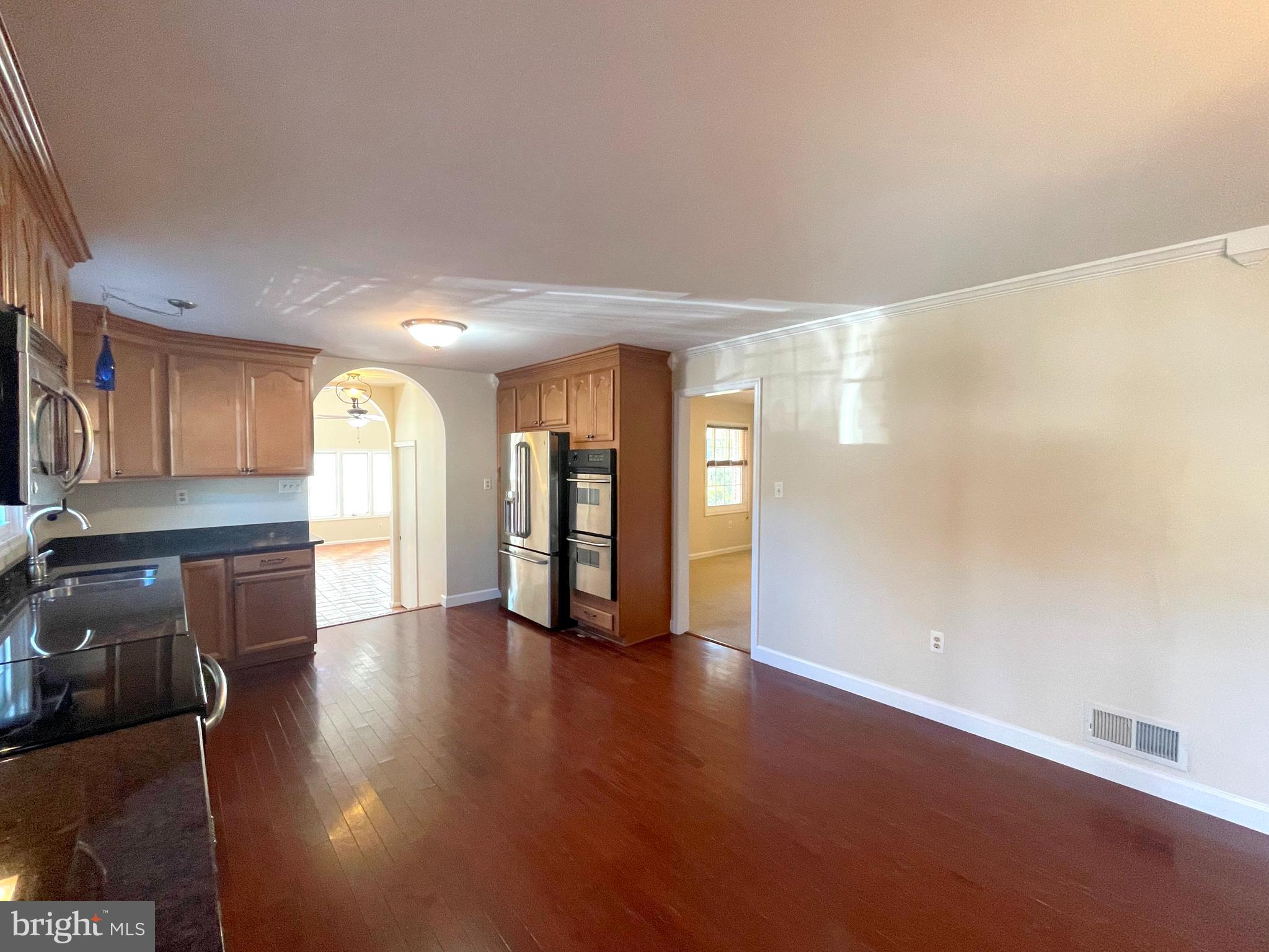 11717 Rivershore Drive Dunkirk, MD 20754 - Photo 7 of 49 a view of a big room with wooden floor and a window