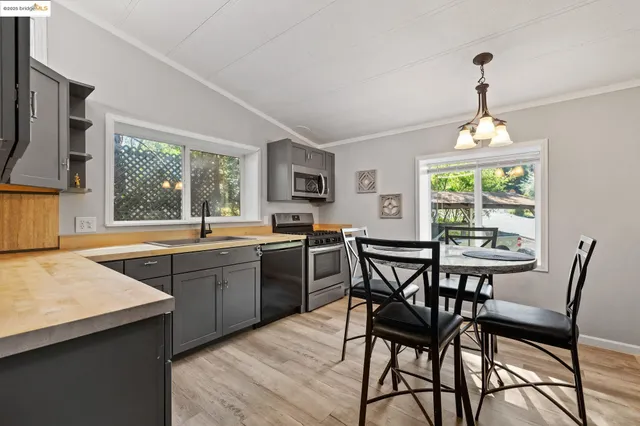 a kitchen with a table chairs sink and window
