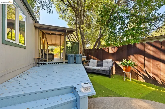 a view of a patio with couches table and chairs and potted plants