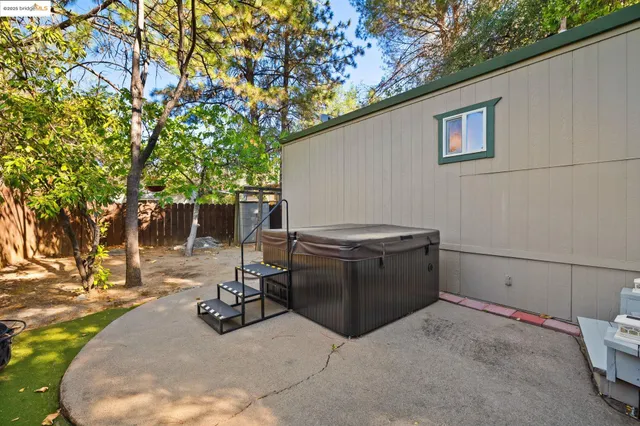 a view of backyard with tub and trees in the background