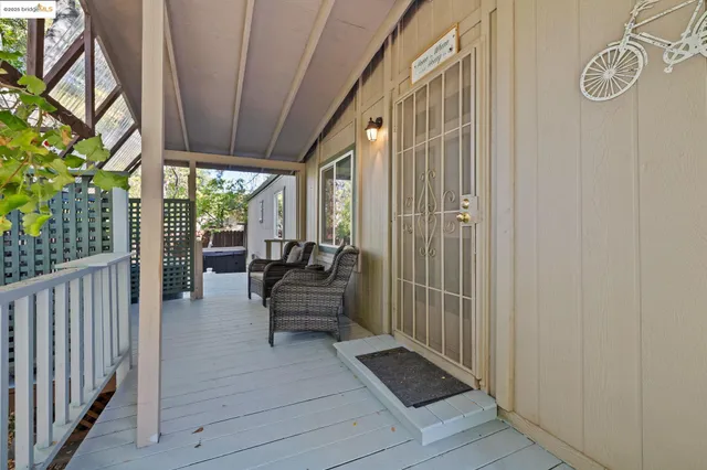a view of a balcony with couch and wooden floor