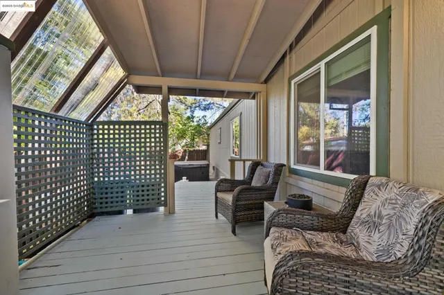 a bedroom with furniture and large windows