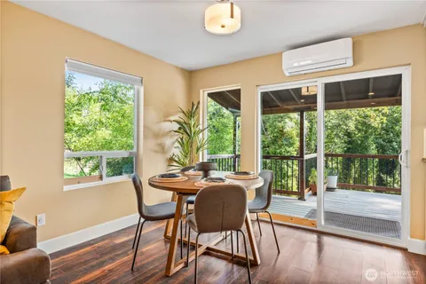 a dining room with furniture a chandelier and wooden floor