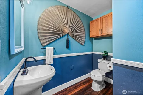 a bathroom with a sink a toilet and mirror