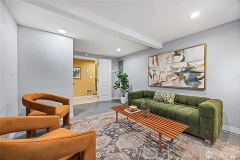 a living room with furniture and a rug