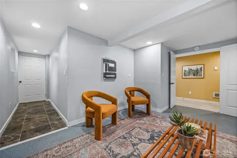 a view of a livingroom with furniture and staircase