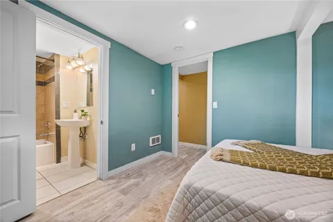 a bedroom with a bed and a view of bathroom