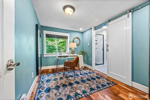 a living room with chair and a rug