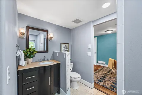 a bathroom with a granite countertop sink toilet and shower