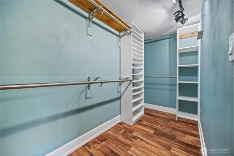 a view of walk in closet with empty racks