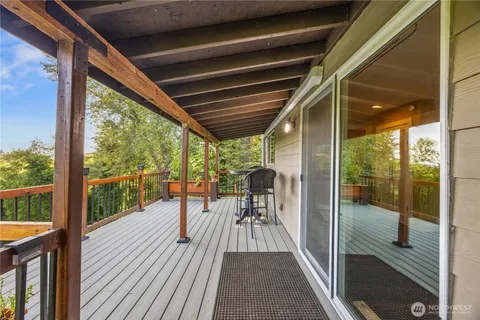 a balcony with furniture and wooden floor