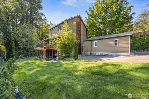 a backyard of a house with table and chairs
