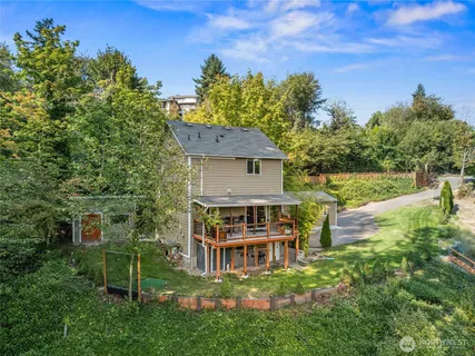 a view of a house with a yard balcony and sitting area