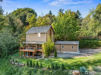 a view of a house with a yard and sitting area