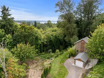 an aerial view of a house with a yard