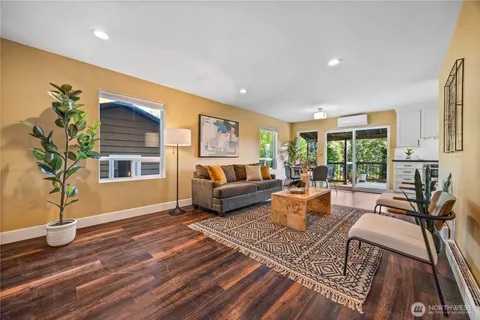 a living room with furniture and a potted plant