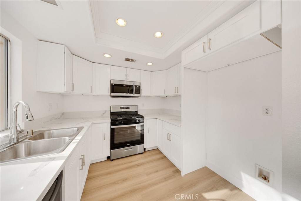 21146 Sunny Ridge Lake Forest, CA 92630 - Photo 20 of 43 a kitchen with a sink stainless steel appliances and cabinets