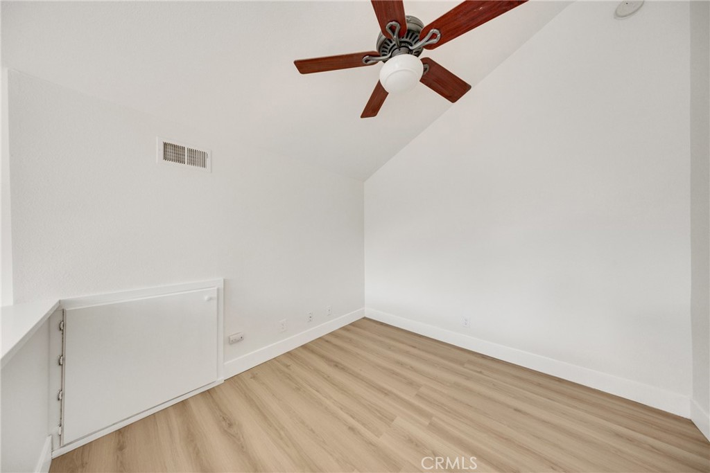 21146 Sunny Ridge Lake Forest, CA 92630 - Photo 24 of 43 an empty room with a ceiling fan and wooden floor
