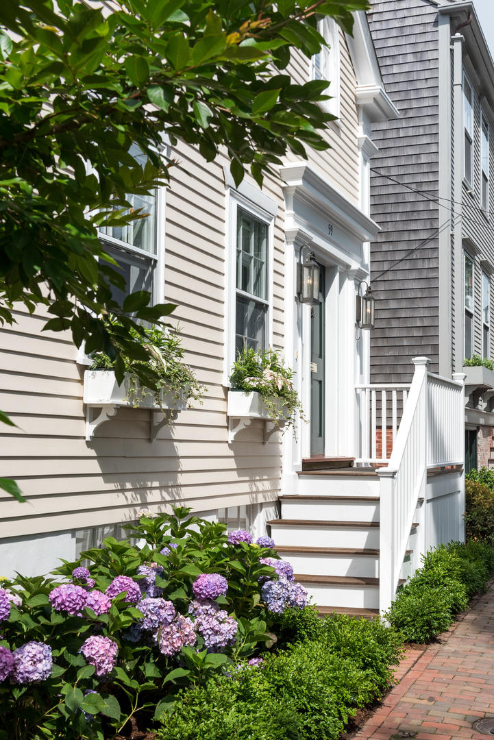 59 Orange Street Nantucket, MA 02554 - Photo 2 of 42 a front view of a house with a garden