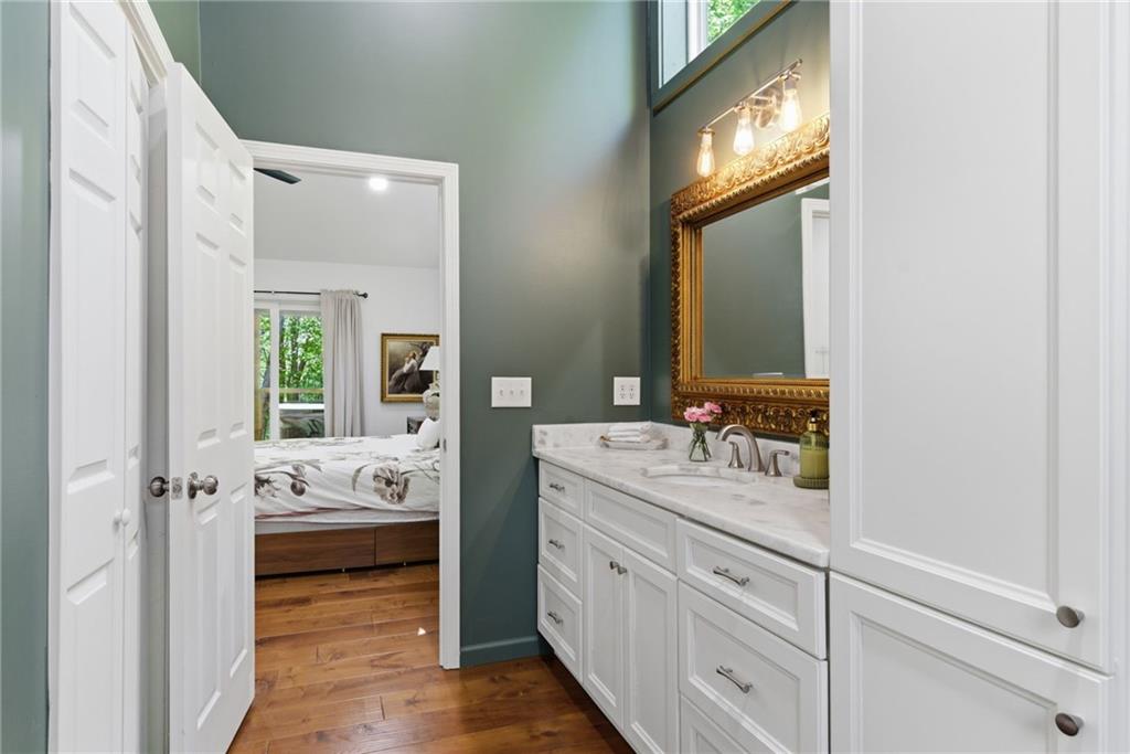191 Oakwood Road Blairsville, GA 30512 - Photo 21 of 43 a en suite bathroom with a double vanity sink a mirror and next to a window