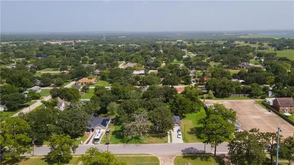 an aerial view of residential houses with city view