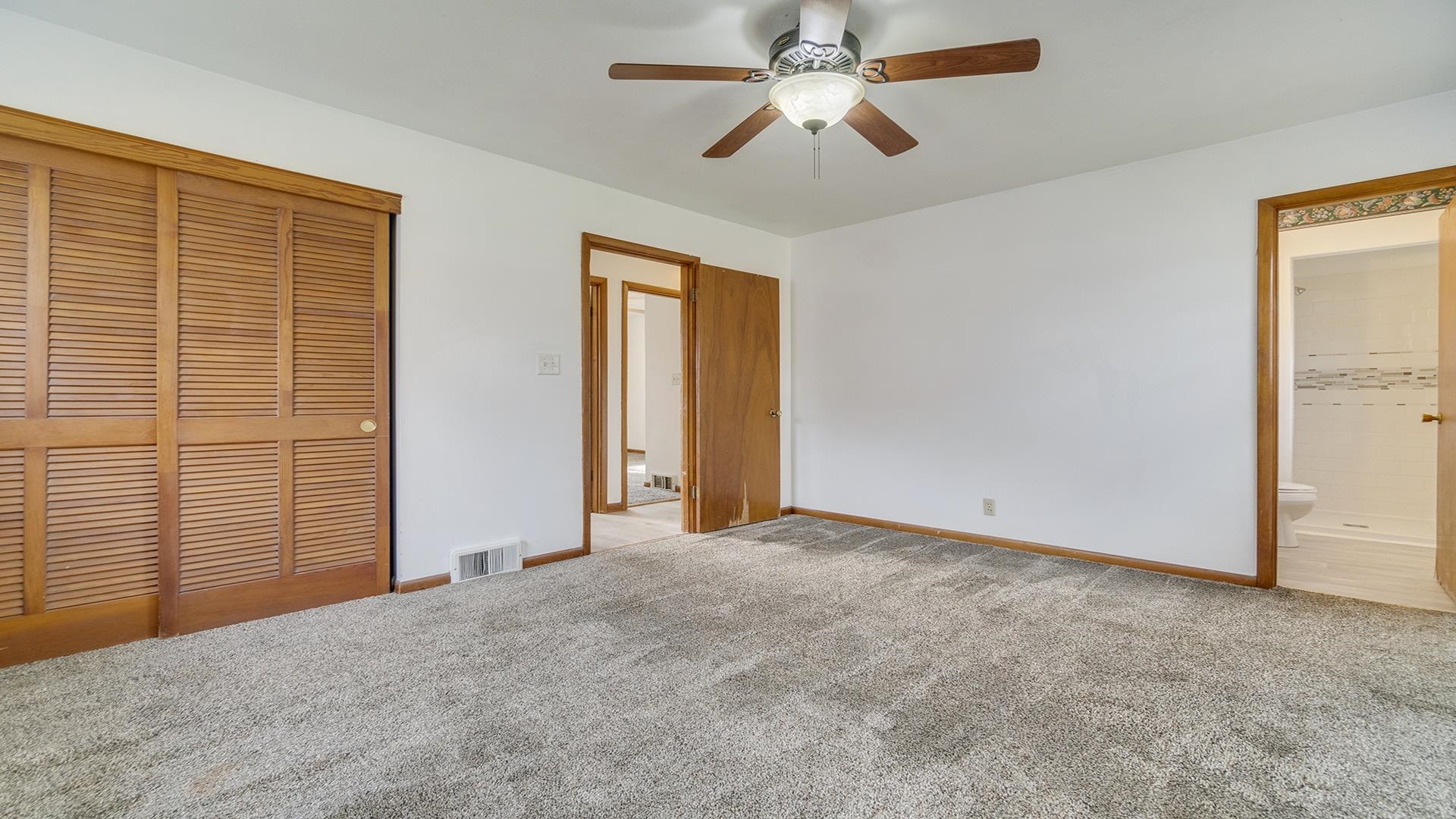 345 Irene Avenue Rochelle, IL 61068 - Photo 11 of 27 an empty room with windows and fan