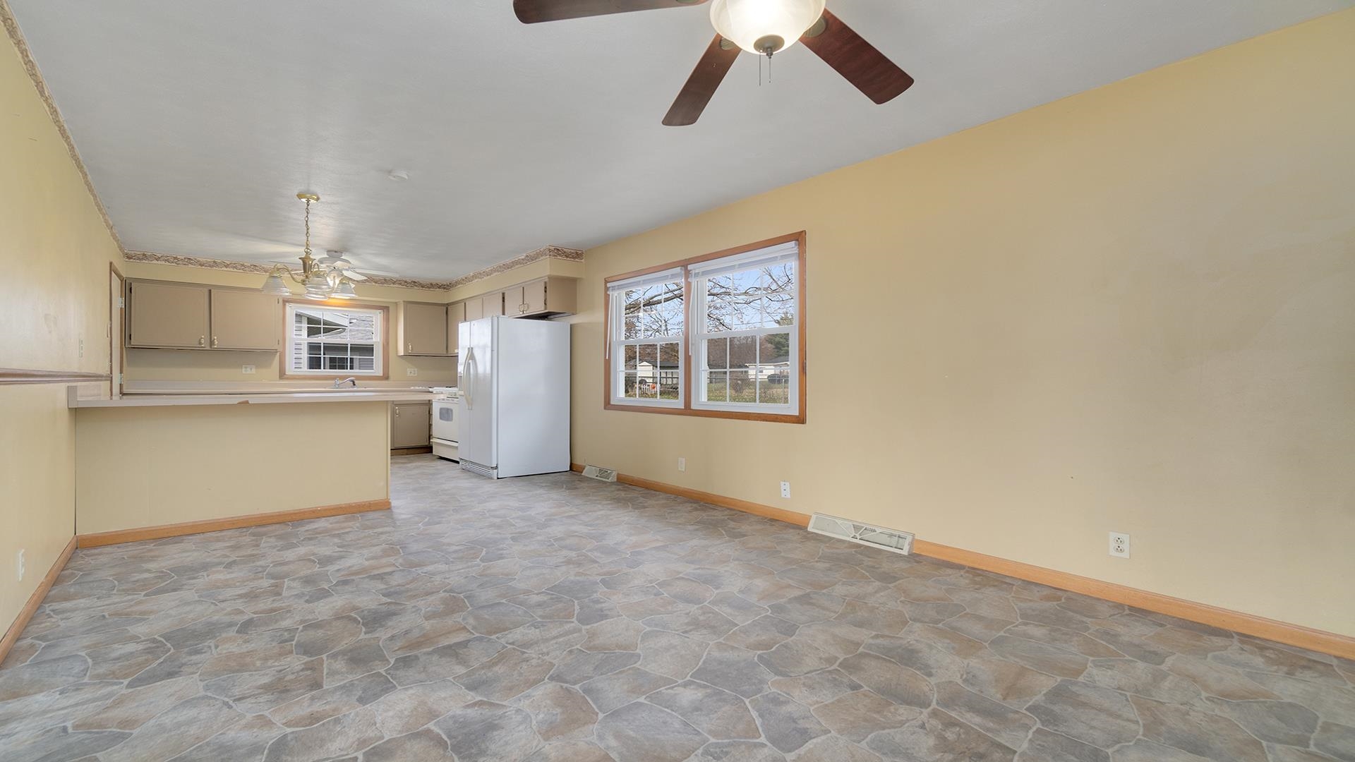 345 Irene Avenue Rochelle, IL 61068 - Photo 13 of 27 a view of a kitchen with furniture and a ceiling fan