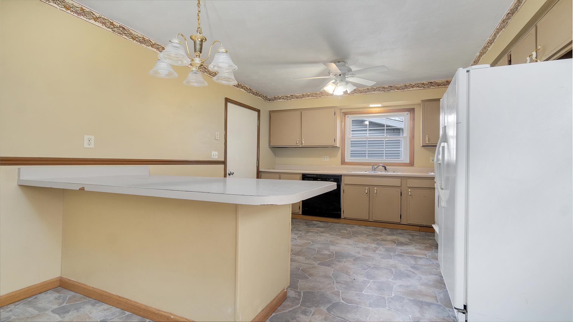 345 Irene Avenue Rochelle, IL 61068 - Photo 15 of 27 a kitchen with a sink dishwasher a stove and a refrigerator with wooden floor