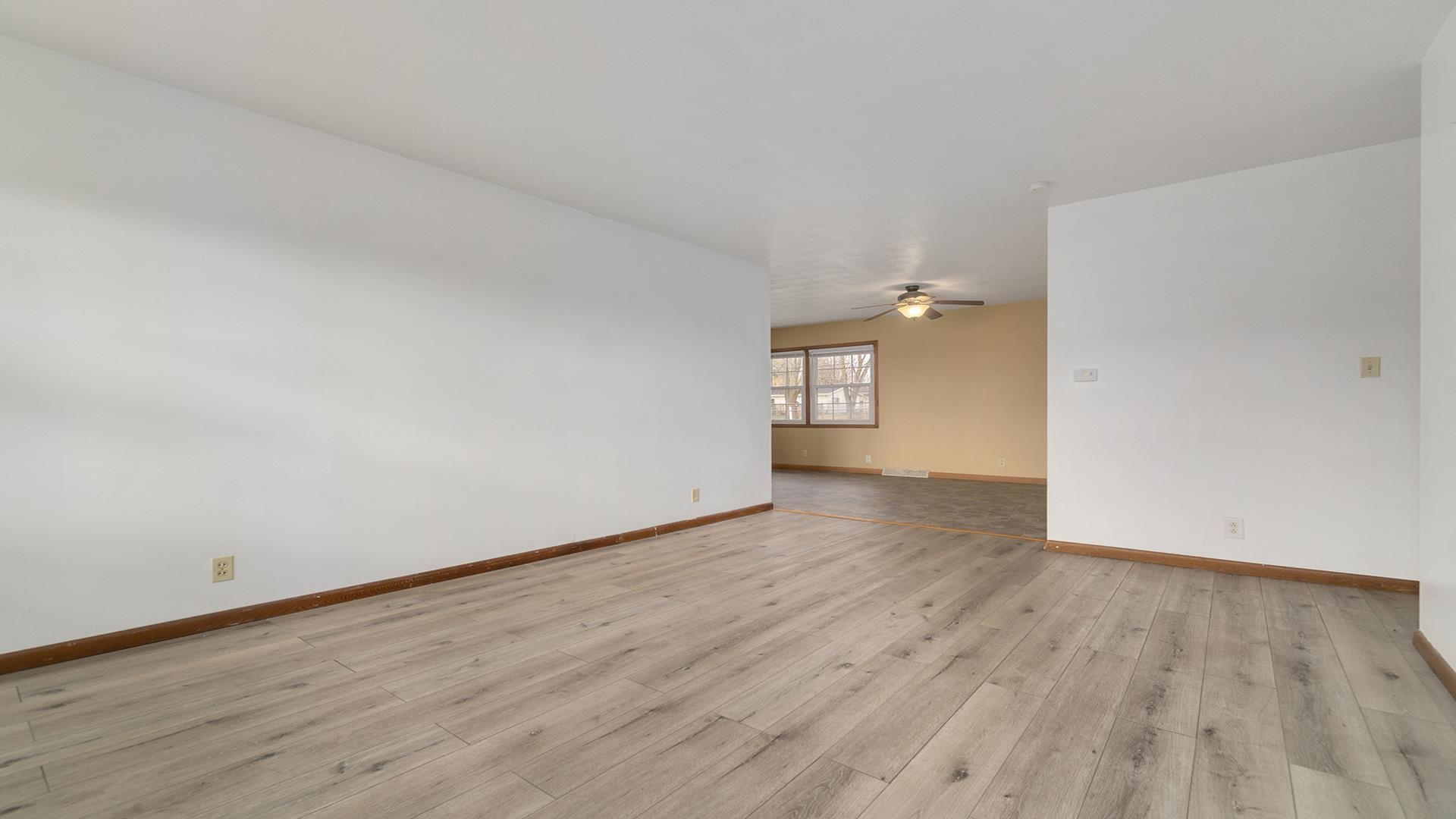 345 Irene Avenue Rochelle, IL 61068 - Photo 3 of 27 a view of an empty room and wooden floor and a window