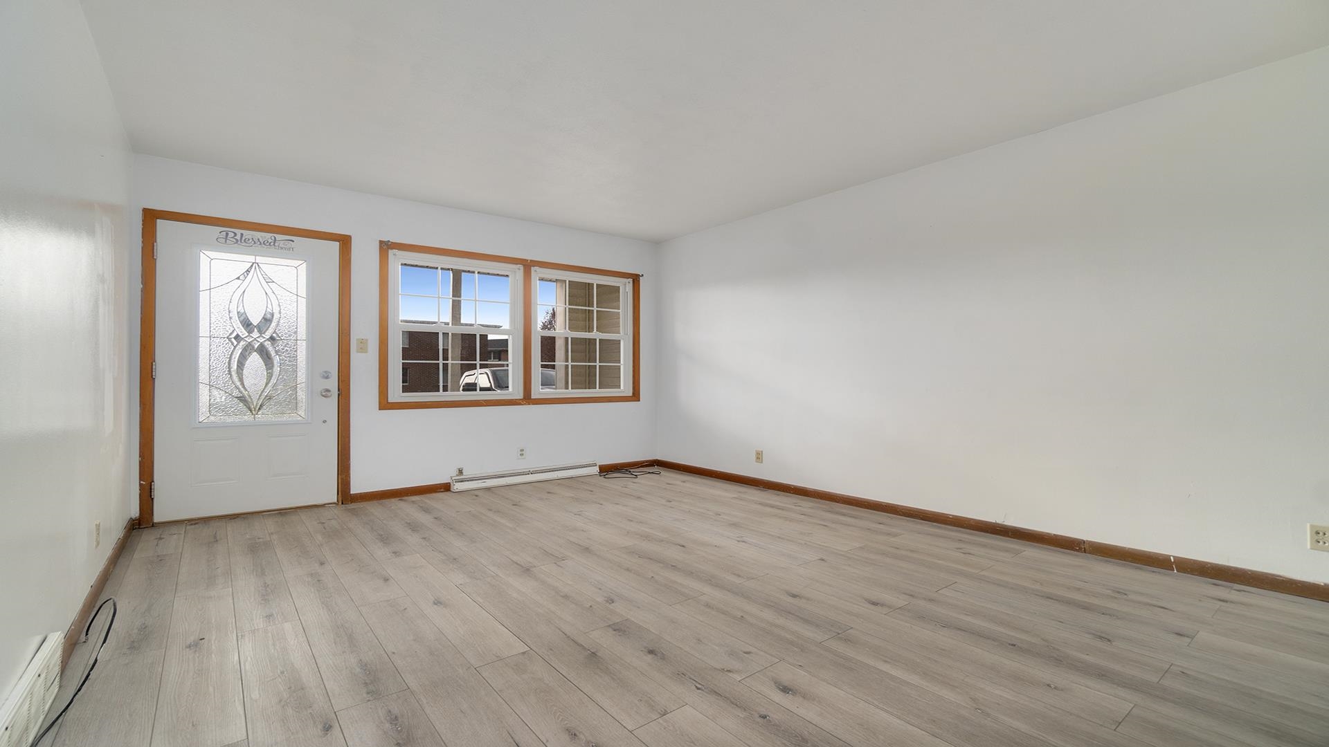 345 Irene Avenue Rochelle, IL 61068 - Photo 4 of 27 an empty room with wooden floor and windows