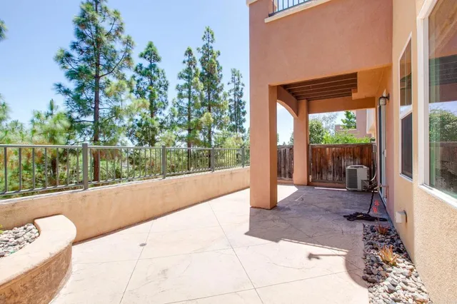 a view of a room with a large window and wooden fence