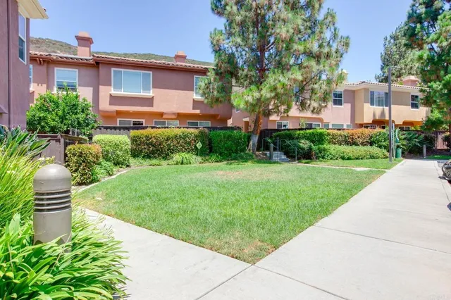 a view of patio with chairs and table under an umbrella