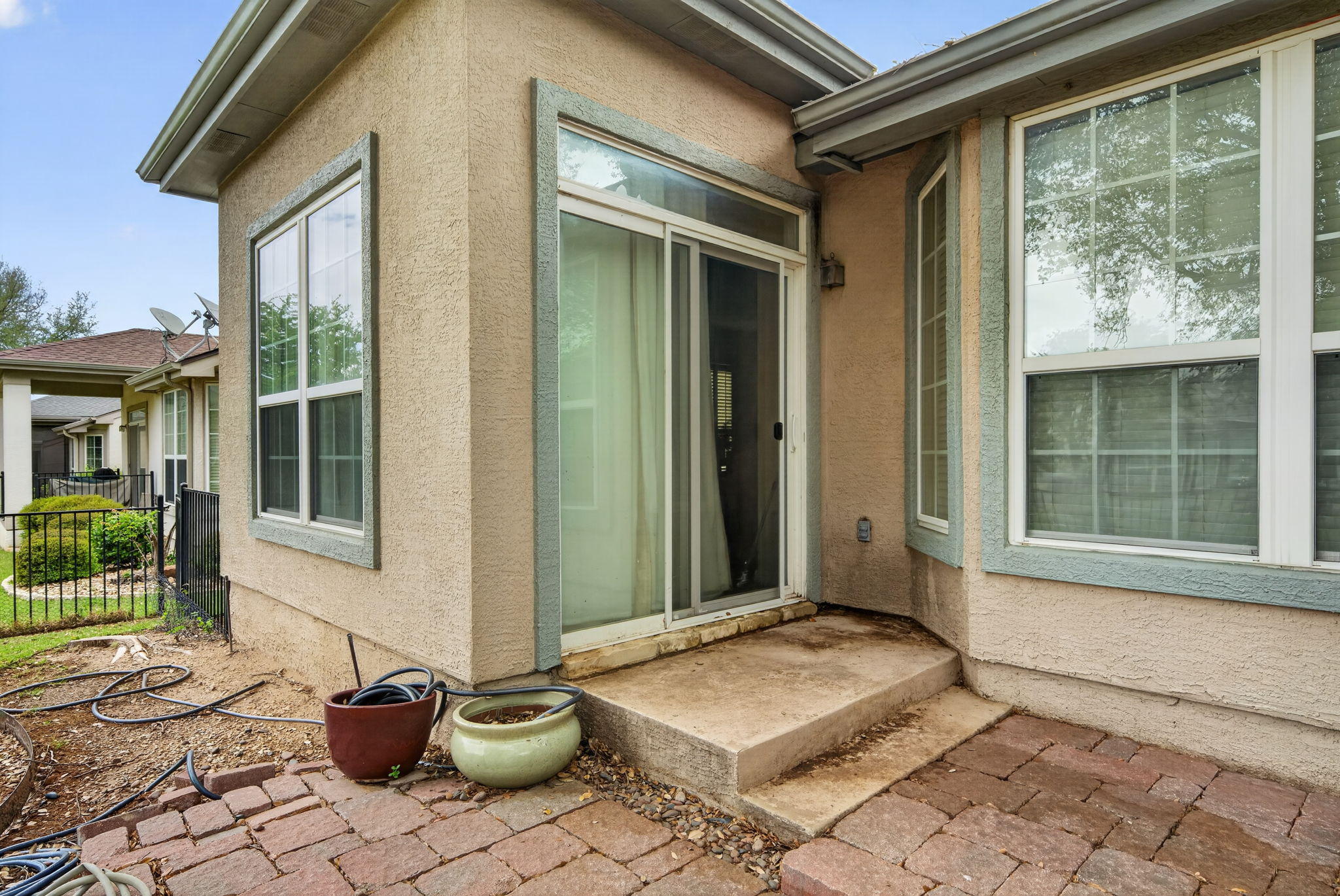 311 Deer Meadow Circle Georgetown, TX 78633 - Photo 16 of 19 a front view of a house with a floor to ceiling window and potted plants