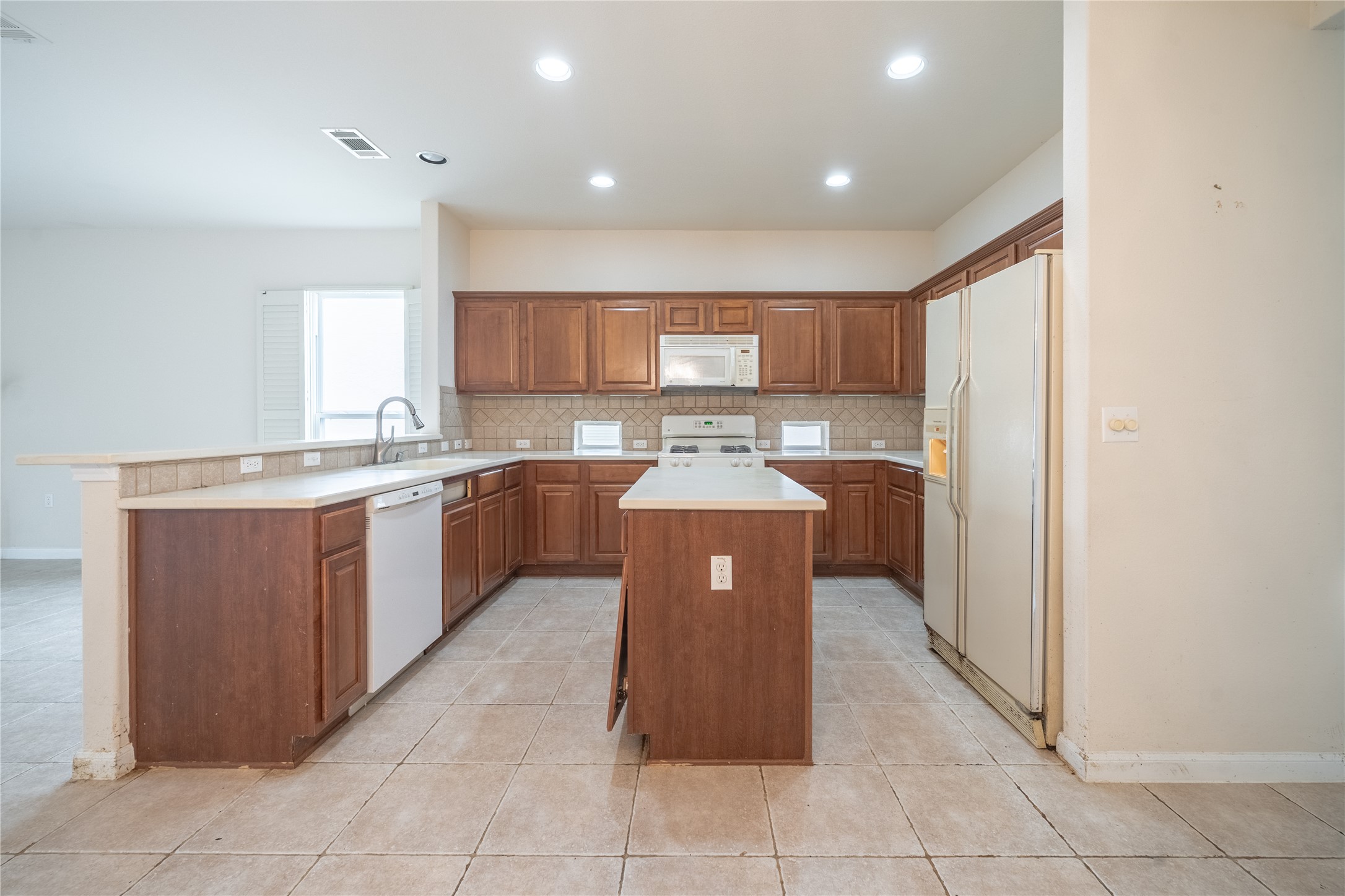 311 Deer Meadow Circle Georgetown, TX 78633 - Photo 7 of 19 a kitchen with stainless steel appliances granite countertop a stove top oven a sink a counter top space and cabinets