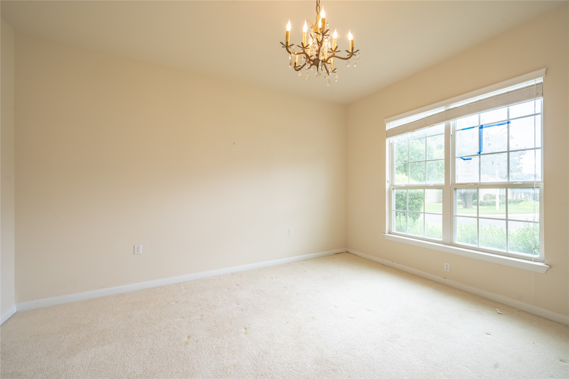 311 Deer Meadow Circle Georgetown, TX 78633 - Photo 8 of 19 an empty room with a chandelier fan and windows