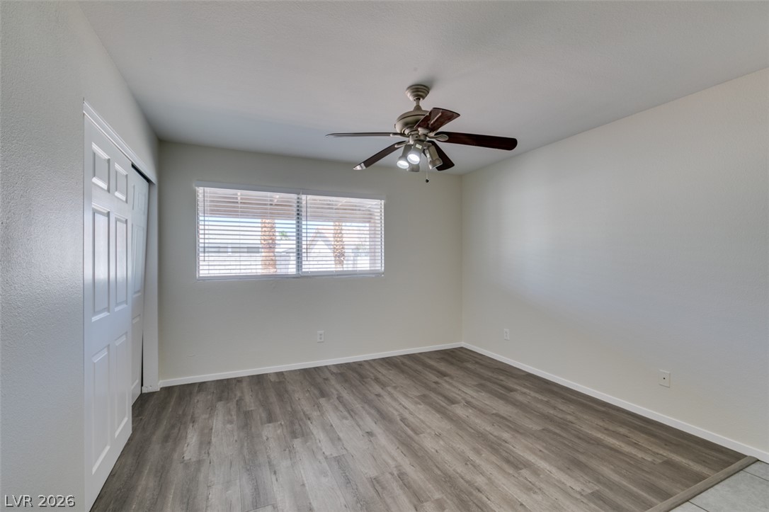2028 Rustler Ridge Avenue North Las Vegas, NV 89031 - Photo 29 of 40 Well-lit room features durable wood-like flooring and a ceiling fan for year-round comfort.