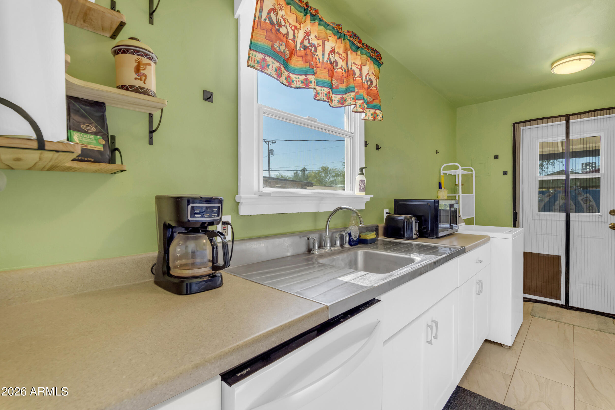 321 Solana Avenue Ajo, AZ 85321 - Photo 11 of 20 a kitchen with a sink and a stove top oven