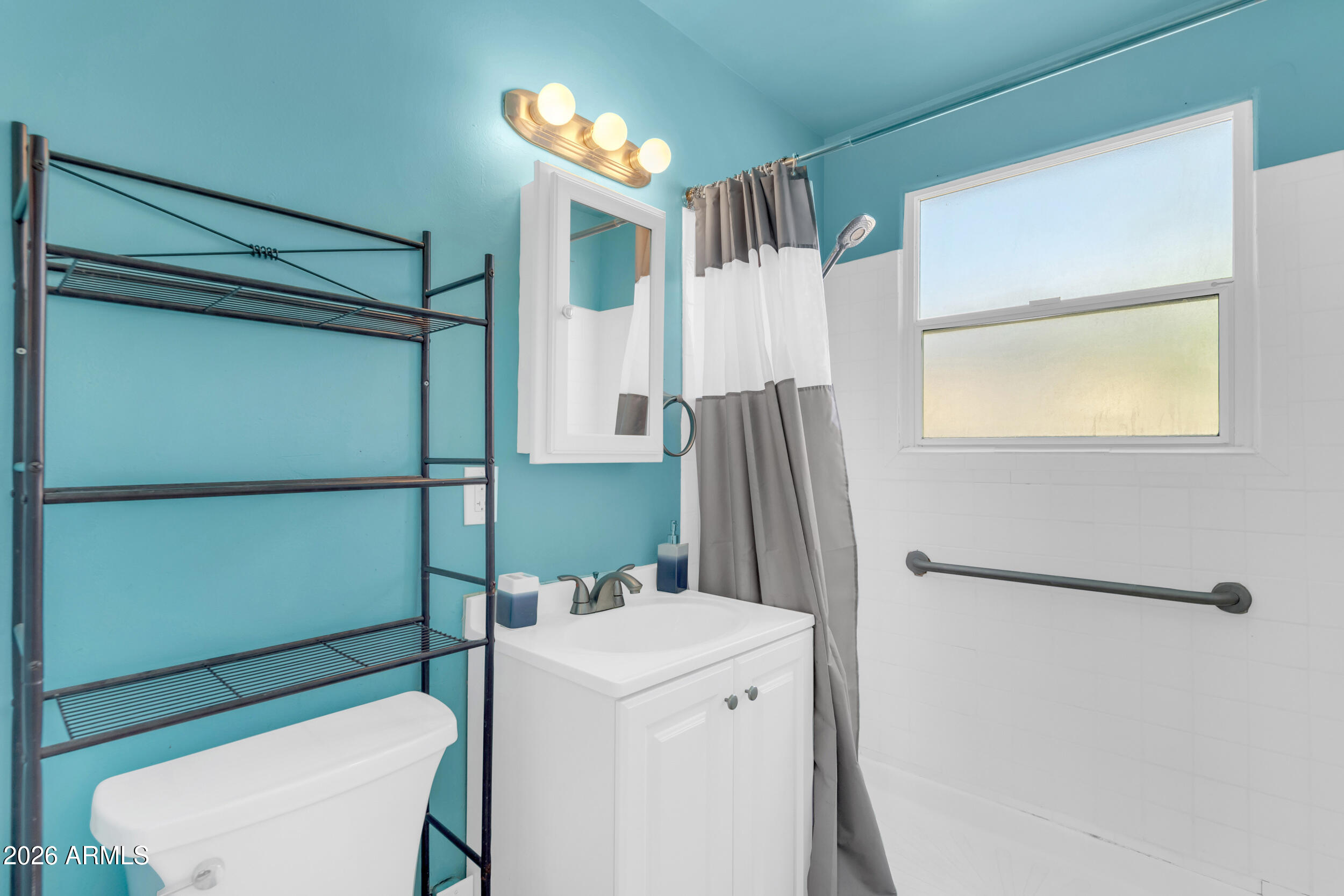 321 Solana Avenue Ajo, AZ 85321 - Photo 13 of 20 a bathroom with a sink a toilet and a shower