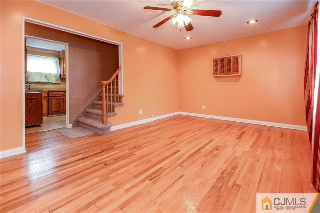 16 Stockton Road New Brunswick, NJ 08901 - Photo 2 of 25 a view of an empty room with wooden floor and a ceiling fan