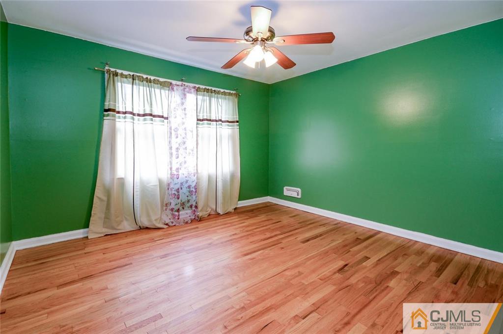 16 Stockton Road New Brunswick, NJ 08901 - Photo 12 of 25 wooden floor in an empty room with a window