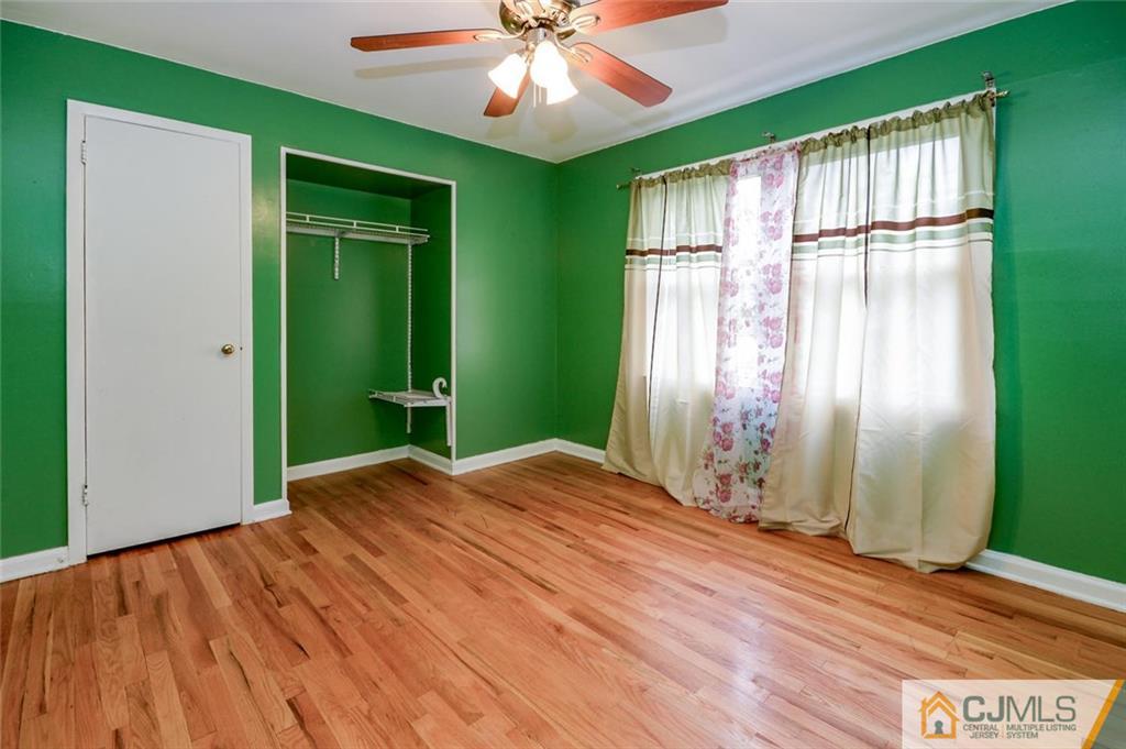 16 Stockton Road New Brunswick, NJ 08901 - Photo 13 of 25 a view of empty room with wooden floor and fan