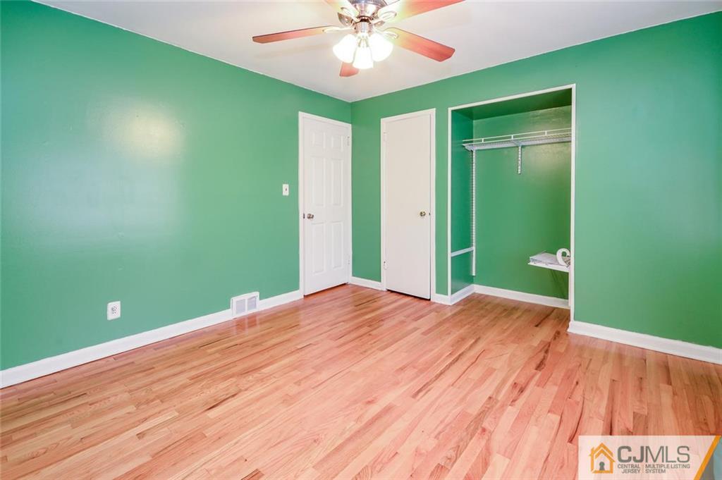 16 Stockton Road New Brunswick, NJ 08901 - Photo 14 of 25 a view of a room with a wooden floor and a ceiling fan