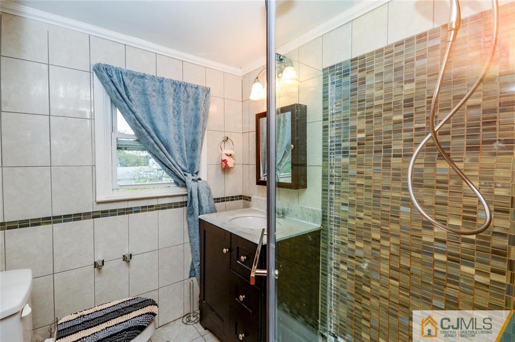 16 Stockton Road New Brunswick, NJ 08901 - Photo 17 of 25 a bathroom with a sink and mirror