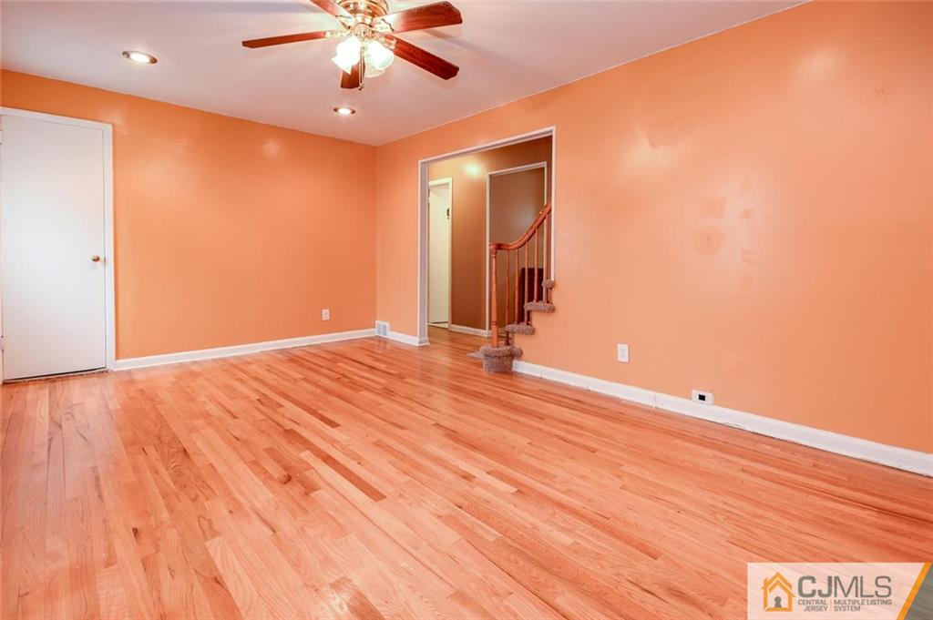 16 Stockton Road New Brunswick, NJ 08901 - Photo 4 of 25 a view of an empty room with window and wooden floor