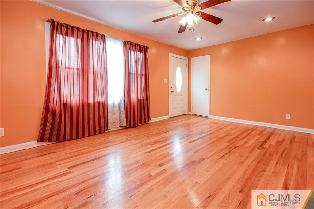 16 Stockton Road New Brunswick, NJ 08901 - Photo 6 of 25 wooden floor in an empty room with a window