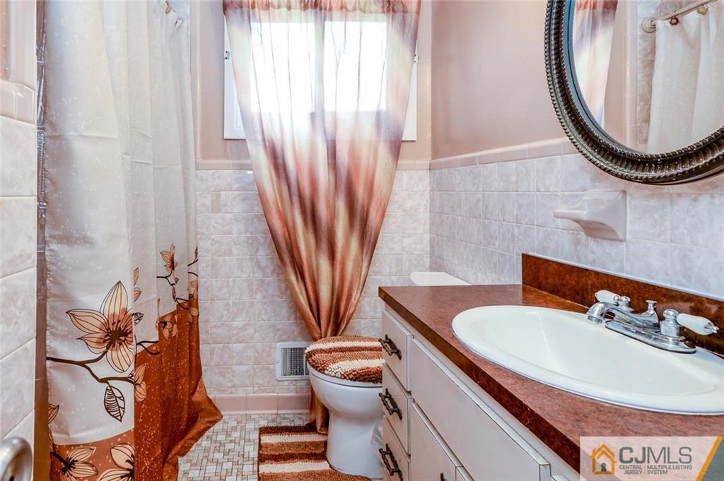 16 Stockton Road New Brunswick, NJ 08901 - Photo 9 of 25 a bathroom with a sink and a mirror