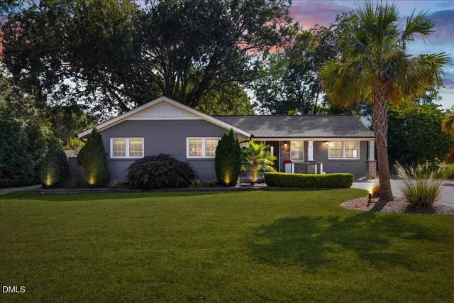 a front view of a house with a garden