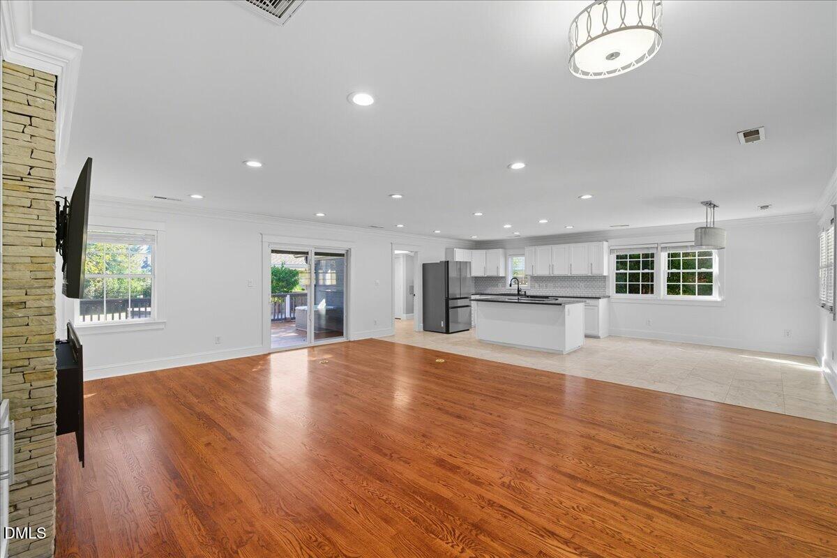 709 Winterlochen Road Raleigh, NC 27603 - Photo 11 of 52 an empty room with wooden floor and windows
