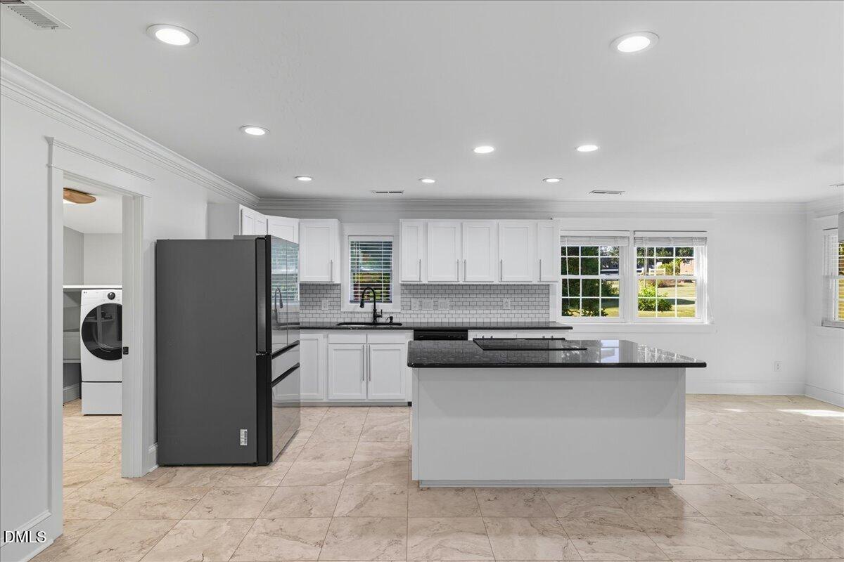 709 Winterlochen Road Raleigh, NC 27603 - Photo 15 of 52 a kitchen with a refrigerator and a stove